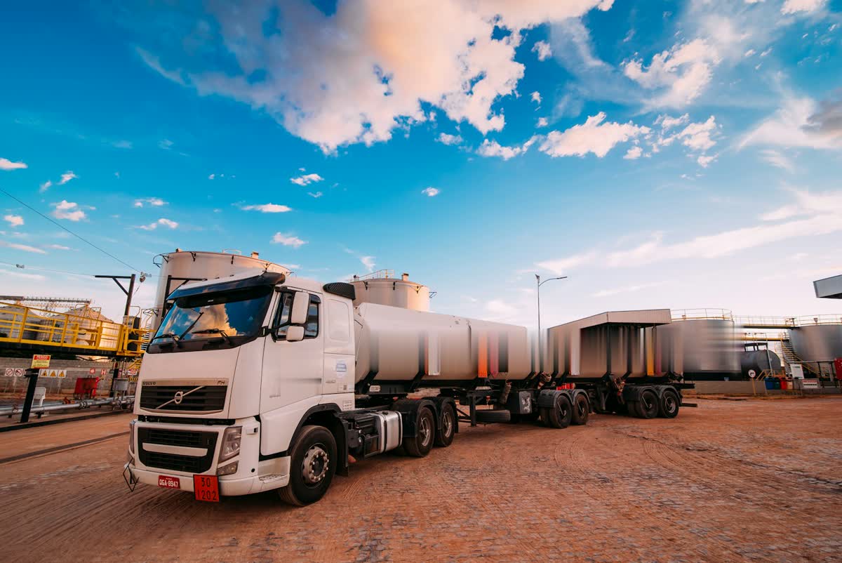 Tanker trucks lined up at an industrial yard on red soil